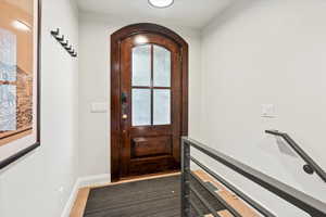 Doorway with baseboards and arched walkways