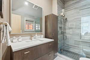 Full bath with vanity and a shower stall