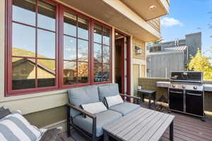 Wooden deck featuring area for grilling