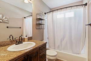 Full bathroom featuring shower / bathtub combination with curtain and vanity