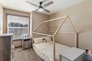 Bedroom featuring light colored carpet and a ceiling fan
