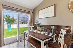 Dining space featuring a mountain view, wood finished floors, and a textured ceiling