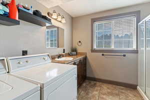 Washroom featuring baseboards and light tile patterned floors