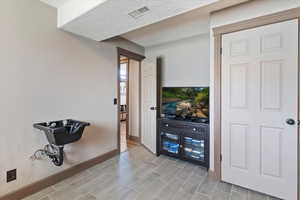 Bar area with wood tiled floors and a textured ceiling