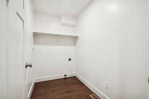 Laundry area with dark wood-style flooring and hookup for an electric dryer