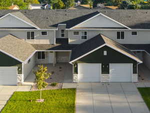 View of front of home with stone siding, driveway, and a mountain view