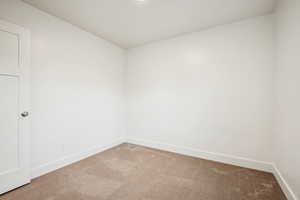 Unfurnished room with carpet and baseboards