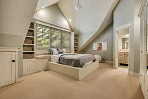 2nd floor Bedroom featuring light colored carpet, high vaulted ceiling, recessed lighting, and connected bathroom