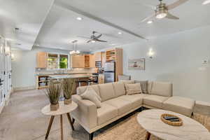 Pool house Living room featuring recessed lighting, ceiling fan, and a chandelier in pool house