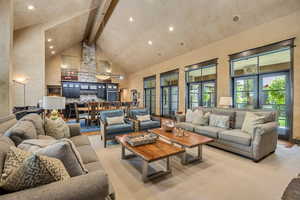 Living room with high vaulted ceiling, beamed ceiling, and recessed lighting
