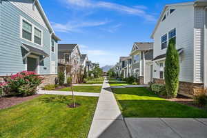 View of community featuring a residential view and a yard