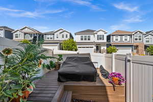 Wooden terrace featuring a residential view
