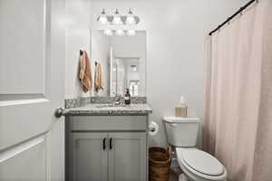 Full bathroom featuring vanity and toilet