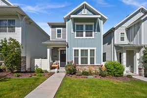 View of front facade with board and batten siding and stone siding