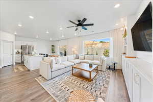 Living area featuring light wood-style floors, recessed lighting, and ceiling fan