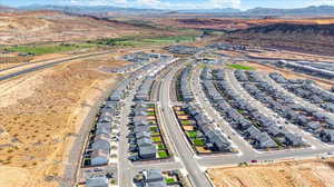 Aerial view of property's location with a mountain backdrop and nearby suburban area