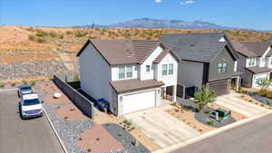 Modern farmhouse style home with board and batten siding, a mountain view, concrete driveway, and an attached garage