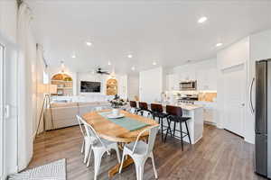 Dining space with recessed lighting, light wood-style floors, a ceiling fan, and built in features