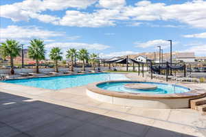 Community pool with a hot tub and a patio