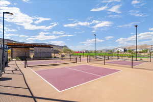 View of tennis court with community basketball court, a mountain view, and a residential view