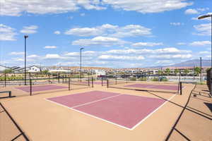 View of tennis court with community basketball court, a mountain view, and a residential view