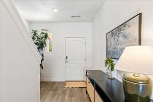 Entrance foyer featuring light wood finished floors and baseboards
