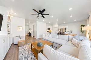 Living area featuring light wood finished floors, recessed lighting, and a ceiling fan