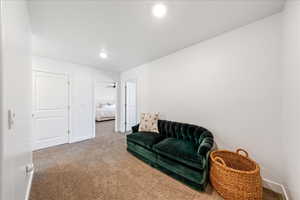 Sitting room with carpet flooring and recessed lighting