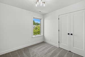 Unfurnished bedroom with carpet floors and a closet