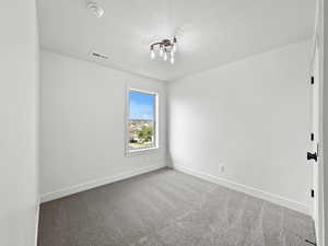 Unfurnished room featuring carpet and baseboards