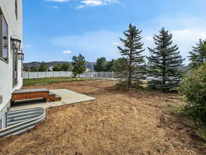 Fenced backyard with a patio and a mountain view
