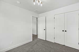 Unfurnished bedroom featuring carpet floors and a closet