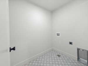 Laundry room with hookup for a washing machine, hookup for an electric dryer, and tile patterned floors