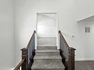 Stairs with carpet and recessed lighting