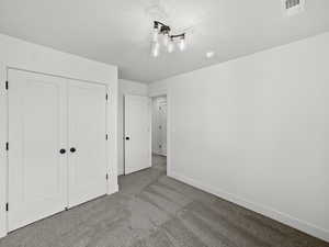 Unfurnished bedroom with carpet floors and a closet