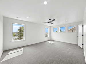 Unfurnished bedroom featuring light carpet, a ceiling fan, and recessed lighting