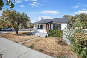 Bungalow with covered porch and a chimney