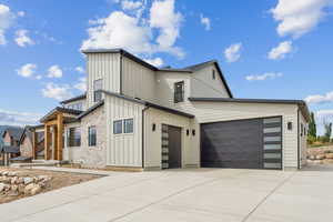 View of front of home featuring board and batten siding and driveway