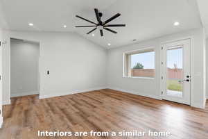 Unfurnished living room featuring vaulted ceiling, light wood finished floors, recessed lighting, and ceiling fan