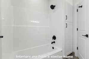 Bathroom featuring washtub / shower combination