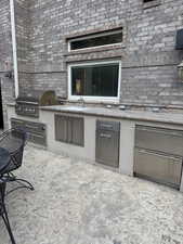 View of patio with a sink and an outdoor kitchen