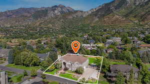 Aerial perspective of suburban area featuring property parcel outlined and mountains