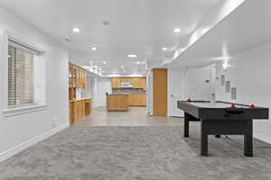 Recreation room featuring light colored carpet and recessed lighting