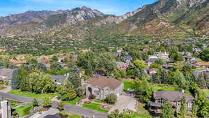 Aerial overview of property's location with a mountainous background and nearby suburban area