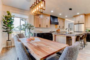 Dining area with light wood-type flooring and recessed lighting