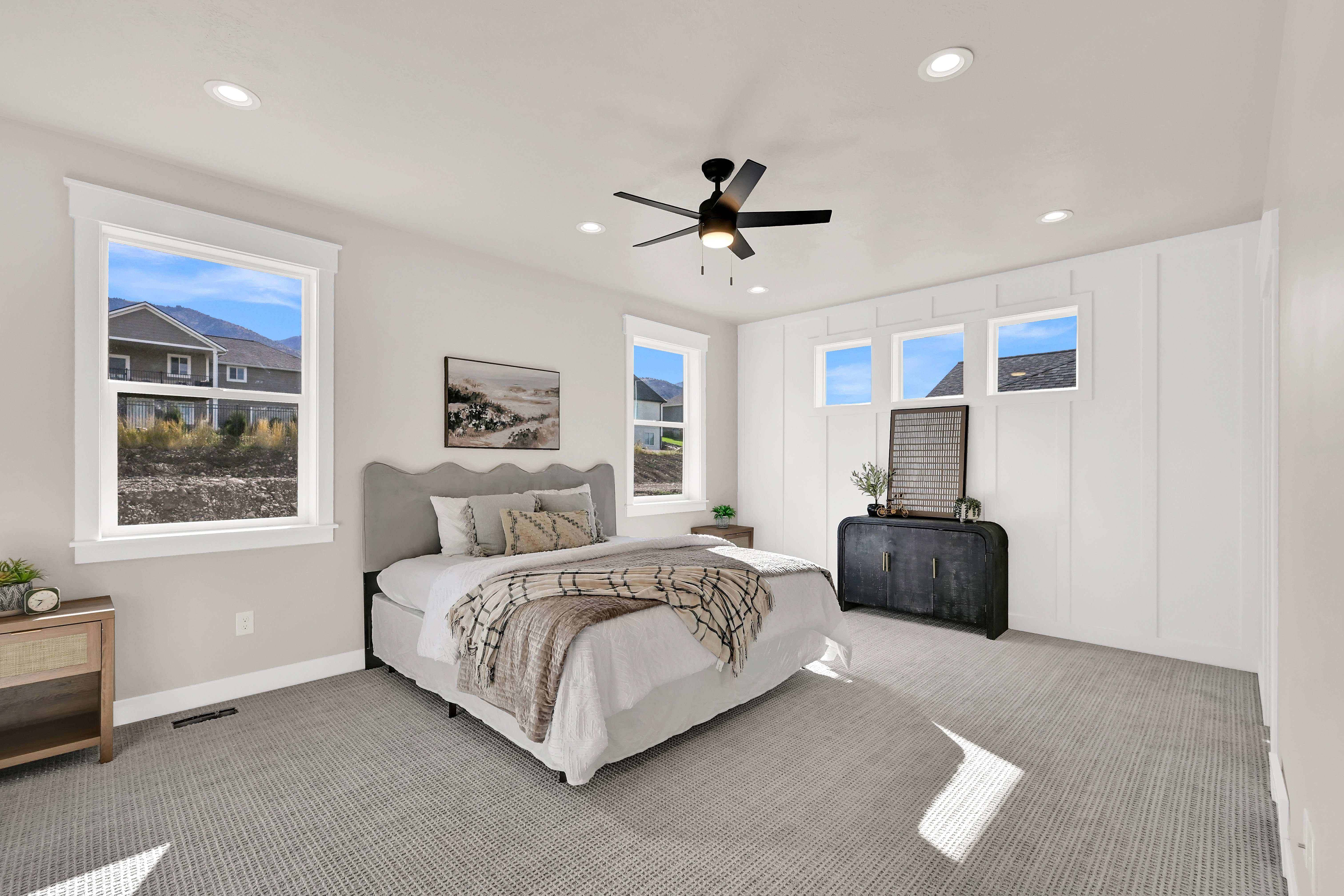 Bedroom with carpet flooring, multiple windows, recessed lighting, ceiling fan, and a decorative wall
