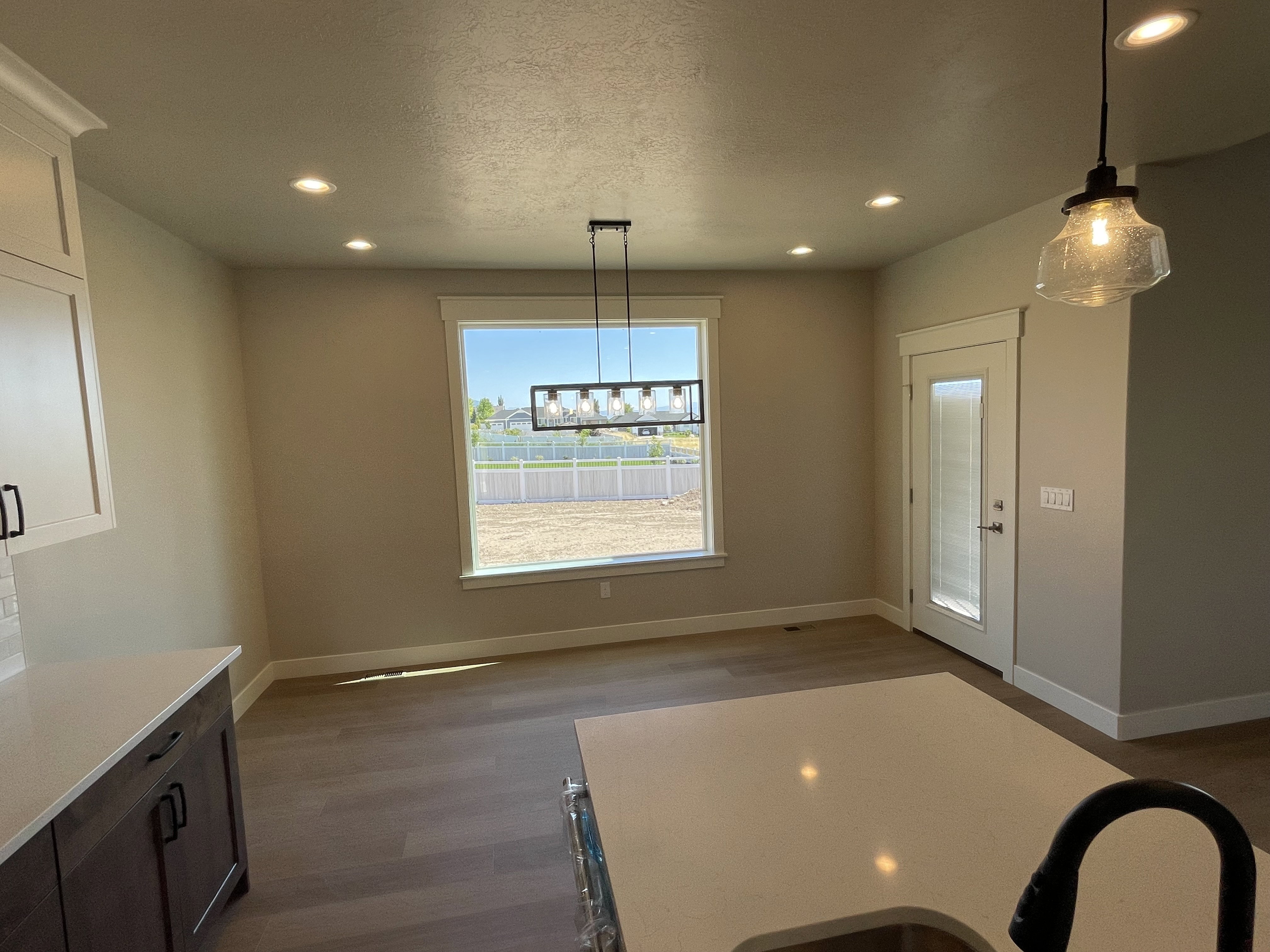 Unfurnished dining area featuring dark wood finished floors and recessed lighting