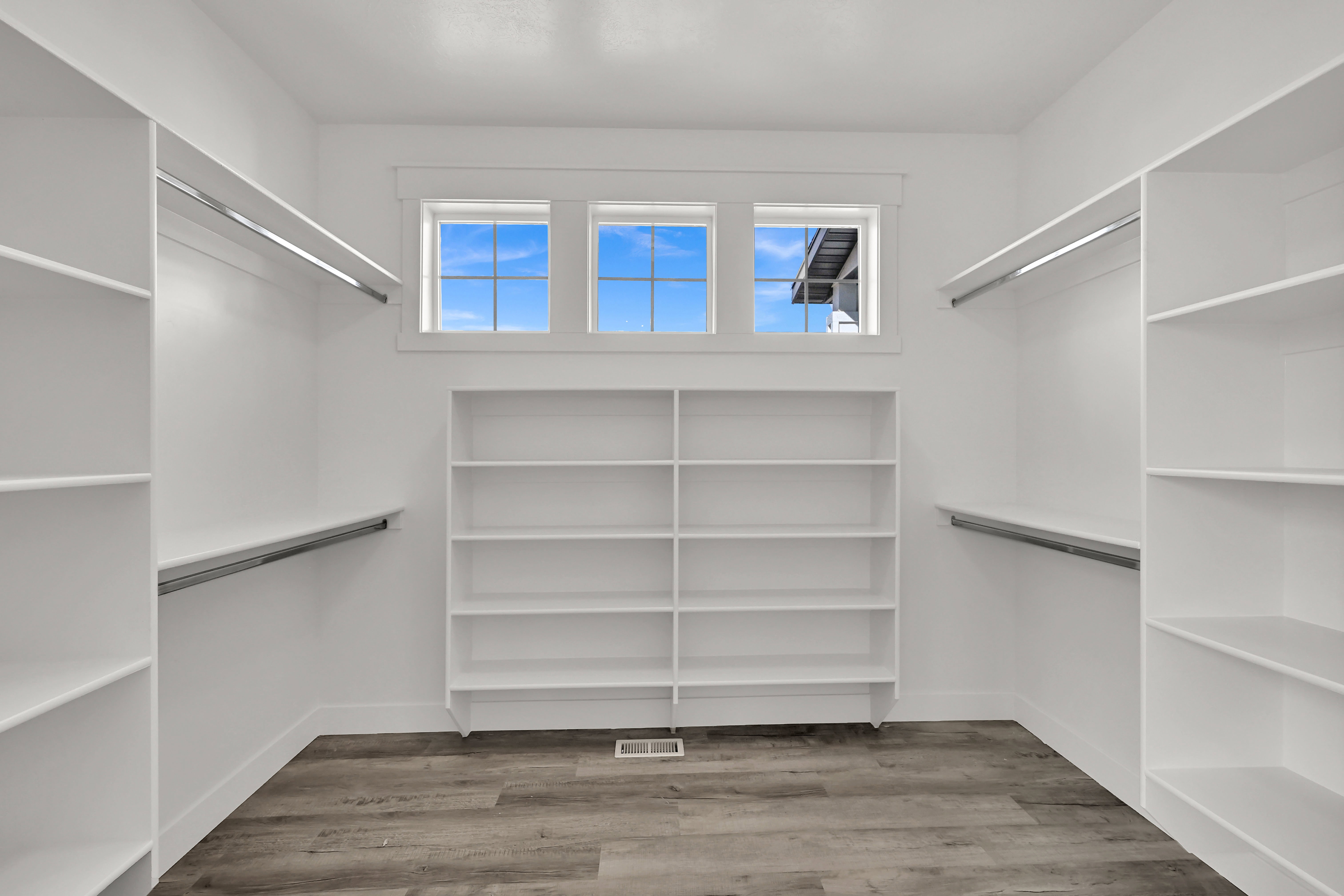 Walk in closet with light wood-style floors
