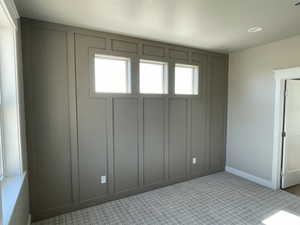 Unfurnished room with a decorative wall and baseboards