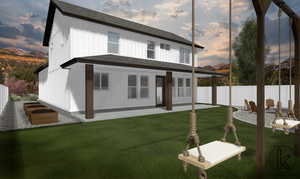 Back of property at dusk with a shingled roof and a patio